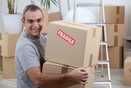 Packed household boxes and furniture ready for urgent removal in Westminster