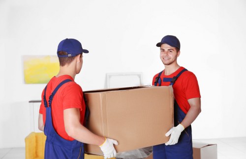 Customer and movers checking access route and fragile items before transport