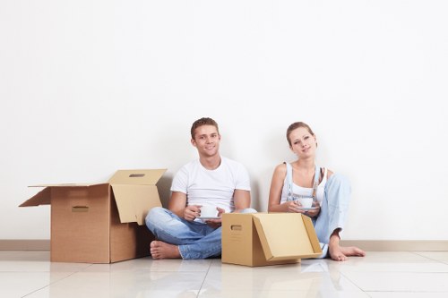Professional movers handling boxes and furniture in a Westminster home