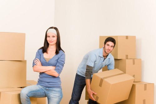 Professional movers handling office furniture and technology during a Westminster relocation
