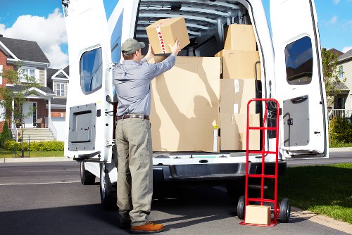Professional movers carrying boxes during a same day move in Westminster